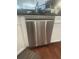 Modern stainless steel dishwasher seamlessly integrated into the kitchen cabinetry with white cabinets at 3311 Lindenridge Dr, Buford, GA 30519