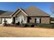 Charming stone-clad house with manicured lawn and inviting outdoor patio area at 3311 Lindenridge Dr, Buford, GA 30519
