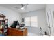 Home office with desk, chair, computer, ceiling fan and window at 3311 Lindenridge Dr, Buford, GA 30519