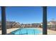 Community pool with clear blue water, surrounded by residential buildings and metal fence at 3311 Lindenridge Dr, Buford, GA 30519