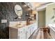 Bathroom featuring a double vanity, patterned wallpaper, and modern fixtures at 3740 Cannonwolde Dr, Snellville, GA 30039