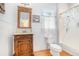 A charming bathroom boasts a wooden vanity, wainscoting, and a classic, elegant design at 3740 Cannonwolde Dr, Snellville, GA 30039