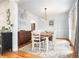 Elegant dining room with a wooden table, chandelier lighting, and hardwood floors at 3740 Cannonwolde Dr, Snellville, GA 30039