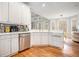 Spacious kitchen featuring white cabinetry, stainless steel appliances, and hardwood floors at 3740 Cannonwolde Dr, Snellville, GA 30039