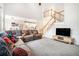 Open-concept living room with a staircase, large windows, and view into the breakfast area and kitchen at 3740 Cannonwolde Dr, Snellville, GA 30039