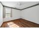 This bedroom features wood-look floor, ceiling fan, and large window for natural light at 6272 Cheatham Lake Nw Dr, Acworth, GA 30101