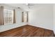 This bedroom features wood-look floors, ceiling fan, and large windows for natural light at 6272 Cheatham Lake Nw Dr, Acworth, GA 30101