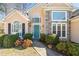 Inviting home entrance featuring a teal door, stone accents, and manicured landscaping at 6272 Cheatham Lake Nw Dr, Acworth, GA 30101