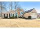 Traditional two-story home featuring stone accents, a manicured lawn, and a two-car garage at 6272 Cheatham Lake Nw Dr, Acworth, GA 30101