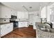 Well-lit kitchen featuring stainless appliances, granite counters, and wood-look flooring at 6272 Cheatham Lake Nw Dr, Acworth, GA 30101