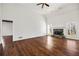 Bright living room featuring a stone fireplace, hardwood floors, and large windows at 6272 Cheatham Lake Nw Dr, Acworth, GA 30101