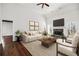 Cozy living room featuring a stone fireplace, hardwood floors, and comfortable seating at 6272 Cheatham Lake Nw Dr, Acworth, GA 30101