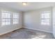 Bedroom featuring carpet, two windows, and white painted walls and trim at 8523 Duncan St, Douglasville, GA 30134