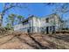 View of the home with an exterior featuring a combination of siding and a spacious backyard at 8523 Duncan St, Douglasville, GA 30134