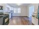 Spacious kitchen featuring modern appliances, wood flooring, and a large window at 8523 Duncan St, Douglasville, GA 30134