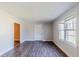 Bright living room with modern, wood-look floors and neutral wall paint creating a cozy feel at 8523 Duncan St, Douglasville, GA 30134