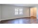 Living room featuring laminate flooring, a window, and white painted walls and trim at 8523 Duncan St, Douglasville, GA 30134