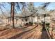 The back of the house showing brick and stucco exterior with mature trees at 123 Creek Cir, Stockbridge, GA 30281