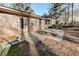 View of the backyard featuring a brick facade and a concrete patio, ideal for outdoor relaxation and entertainment at 123 Creek Cir, Stockbridge, GA 30281