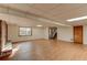 Open basement space with wood-look flooring, a brick fireplace, and walkout access at 123 Creek Cir, Stockbridge, GA 30281