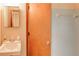 Bathroom featuring blue tiled shower, sink, and mirror in a compact design at 123 Creek Cir, Stockbridge, GA 30281