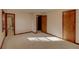 Bright bedroom with warm-toned trim, doors, and natural light from bathroom and closet entrances at 123 Creek Cir, Stockbridge, GA 30281