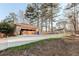 A two-car detached garage with an expansive driveway and mature trees at 123 Creek Cir, Stockbridge, GA 30281