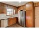 Cozy kitchen featuring wood cabinets, stainless steel refrigerator, and a bright window at 123 Creek Cir, Stockbridge, GA 30281