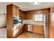 A cozy kitchen featuring wood cabinets, stainless steel appliances, and ample counter space at 123 Creek Cir, Stockbridge, GA 30281
