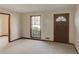 A neutrally decorated living room showcasing carpet floors and a large window at 123 Creek Cir, Stockbridge, GA 30281