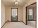 An empty living room displaying carpeted floors and natural light at 123 Creek Cir, Stockbridge, GA 30281