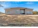 Back exterior with patio, lawn, and neutral siding at 17 Denny Springs Dr, Dallas, GA 30157