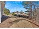 Wide view of large, level backyard with partial fence and bare trees at 17 Denny Springs Dr, Dallas, GA 30157