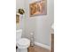 Powder room with neutral paint, floating shelves and classic fixtures at 17 Denny Springs Dr, Dallas, GA 30157