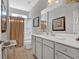 Bathroom showcasing double vanity, framed mirrors, and shower with curtain at 17 Denny Springs Dr, Dallas, GA 30157