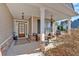 Inviting front porch features stone accents, seating, and a paneled front door, creating curb appeal at 17 Denny Springs Dr, Dallas, GA 30157