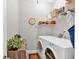 Bright laundry room with front loading washer and dryer plus storage at 17 Denny Springs Dr, Dallas, GA 30157