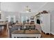 Bright living room with hardwood floors, ceiling fan and fireplace, with an adjacent kitchen and dining area at 17 Denny Springs Dr, Dallas, GA 30157