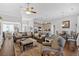 Spacious living room featuring hardwood floors, gray couches, and a smooth transition to the open-plan kitchen at 17 Denny Springs Dr, Dallas, GA 30157