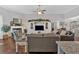 Open-concept living room with fireplace, media center and gray couches and adjoining kitchen and dining space at 17 Denny Springs Dr, Dallas, GA 30157