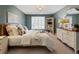 Comfortable bedroom with an area rug, ample natural light, and neutral-colored walls at 3040 Greatwood Xing, Alpharetta, GA 30005