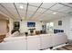 Finished basement featuring a modular ceiling, light-colored sofa, arcade game, and exterior access at 4014 Ironhill Ln, Woodstock, GA 30189