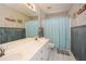 Bathroom featuring double sink vanity, nautical wall decor, and patterned shower curtain at 4014 Ironhill Ln, Woodstock, GA 30189