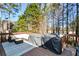 Wooden deck with cozy seating and a grill, perfect for outdoor relaxation and entertaining at 4014 Ironhill Ln, Woodstock, GA 30189