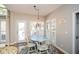 Bright dining area with natural light, a round table, and white chairs near a deck access at 4014 Ironhill Ln, Woodstock, GA 30189