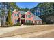 Attractive brick home featuring a well-manicured lawn and mature plantings in a desirable residential neighborhood at 4014 Ironhill Ln, Woodstock, GA 30189