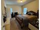 This comfortable bedroom features a double bed and natural light from two windows at 1366 Image Xing, Lawrenceville, GA 30045