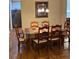 Dining room features hardwood floors, neutral walls, and a decorative chandelier at 1366 Image Xing, Lawrenceville, GA 30045