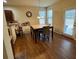 Bright dining area with a modern chandelier, hardwood floors, and a sliding glass door for easy outdoor access at 1366 Image Xing, Lawrenceville, GA 30045