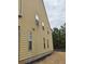 Exterior shot of the side of a tan colored house with some vegetation at 1366 Image Xing, Lawrenceville, GA 30045